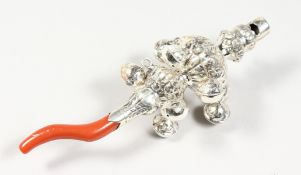 A SILVER AND CORAL RATTLE WITH BELLS. 5.5ins long.