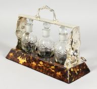 A SILVER PLATE AND TORTOISESHELL THREE BOTTLE TANTALUS.