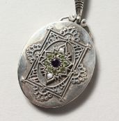 A SILVER, PERIDOT, PEARL AND AMETHYST SUFFRAGETTE STYLE LOCKET.