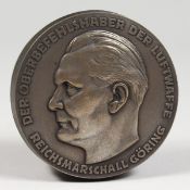 A CIRCULAR EMBOSSED METAL NAZI BOX AND COVER 