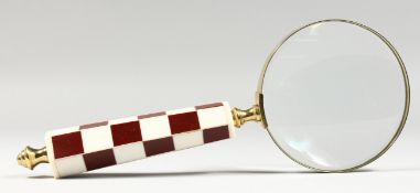 A MAGNIFYING GLASS.