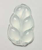 AN UNUSUAL SEMI-OPAQUE JADE LEAF SHAPE PENDANT. 2ins long.