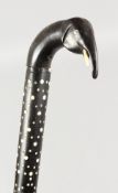 A CEYLONESE CARVED WALKING STICK with elephant handle. 33ins long.