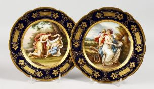 A GOOD PAIR OF 19TH CENTURY VIENNA PLATES, rich blue and gilt borders, painted with classical