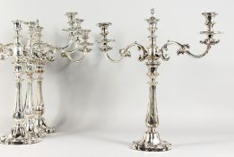 A VERY GOOD SET OF FOUR SHEFFIELD PLATE TWO-BRANCH CANDELABRA, with scrolling branches. 18.5ins