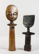 TWO AFRICAN CARVED WOOD DOLL FIGURES. 15ins and 12ins long.
