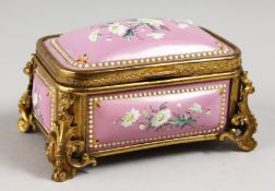 A GOOD CONTINENTAL PINK ENAMEL JEWELLERY BOX, with gilt mounts painted with flowers. 4.5ins long.