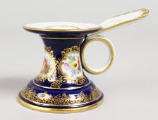 A SMALL MEISSEN RICH BLUE TAPER STICK, with three panels of figures and flowers. Cross swords mark