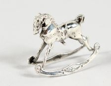 A MINIATURE SILVER ROCKING HORSE.