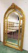 A LARGE IMPRESSIVE GILT FRAMED ARCH TOP MIRROR. 7ft 4ins high x 3ft 10ins wide.