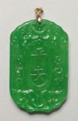 A CHINESE CARVED APPLE GREEN JADE PENDANT. 2.25ins high.