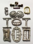 A BAG OF VARIOUS BUCKLES.