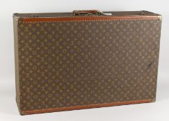 A VERY GOOD LOUIS VUITTON SUITCASE. 51.5ins long x 21ins wide x 8.5ins deep.