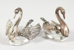A PAIR OF SILVER MOUNTED GLASS SWAN SHAPE SALTS. 3ins long.