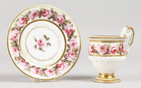 A PARIS CUP AND SAUCER, the cup with footed, unglazed basal flutes, the scroll handle moulded with