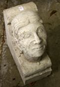 A RECONSTITUTED STONE CORBEL OF A MANS HEAD. 19ins high x 8ins wide x 14ins deep.