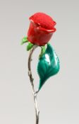 A SILVER AND ENAMEL MODEL OF A ROSE. 2.5ins long.