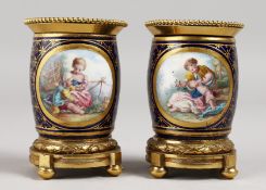 A VERY GOOD PAIR OF SEVRES RICH BLUE ORMOLU MOUNTED VASES, painted with reverse panels of figures