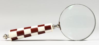A MAGNIFYING GLASS.