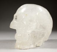 A LARGE CRYSTAL MOSER OF A HUMAN SKULL. 7ins long.