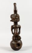 AN AFRICAN CARVED WOOD FIGURE AS A PIPE. 10ins long.