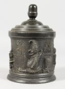 AN UNUSUAL VICTORIAN PEWTER TOBACCO BOX, with Mr Punch decoration. 6.5ins high.