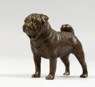 A SMALL CAST BRONZE MODEL OF A DOG. 3ins long.