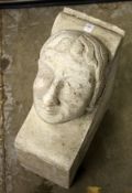 A RECONSTITUTED STONE CORBEL OF A MANS HEAD. 21ins high x 8ins wide x 15ins deep.