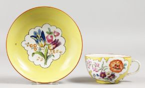 A MEISSEN YELLOW GROUND CUP AND SAUCER painted with figures. Blue mark.
