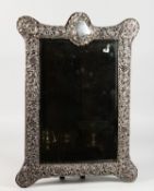 A GOOD UPRIGHT EASEL MIRROR, pierced silver on velvet. 19ins high x 14ins wide. Chester 1902.
