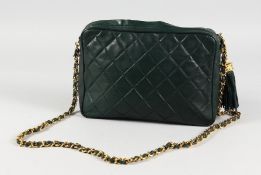 A DARK GREY CHANEL BAG with gilt metal strap. 9ins long.