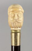 A WALKING STICK, the bone handle carved as a bust of a man. 35.5ins long.