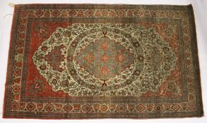 A GOOD PERSIAN RUG, EARLY 20TH CENTURY, beige ground, with floral decoration, signed. 7ft 6ins x 4ft