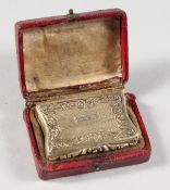 A GEORGE IV SHAPED AND ENGINE TURNED VINAIGRETTE. Birmingham 1826. Maker: IT. In a leather case.