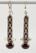 A PAIR OF SILVER AND GARNET EARRINGS.