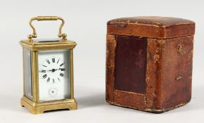 A SMALL BRASS CARRIAGE CLOCK, in leather case. 3ins high.