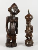TWO AFRICAN CARVED WOOD FIGURES. 18ins and 14ins high.