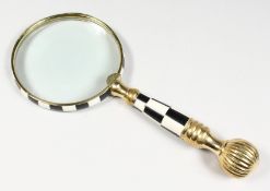 A MAGNIFYING GLASS.