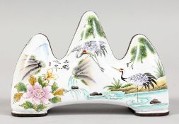 A CHINESE ENAMEL BRUSH REST, painted with cranes. 3.75ins long.