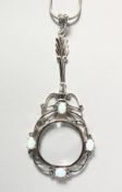 A SILVER AND OPAL SPY GLASS on a chain.