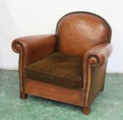 A 1930'S BROWN LEATHER UPHOLSTERED ARMCHAIR. 2ft 7ins high x 2ft 11ins wide.