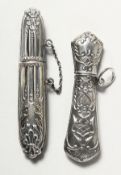 TWO SILVER NEEDLE CASES.