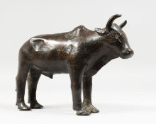 A BRONZE MODEL OF A STANDING BULL. 9ins long.
