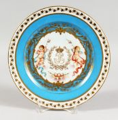 A GOOD SEVRES CABINET PLATE, the centre with a gilt monogram, with a cherub to each side within a