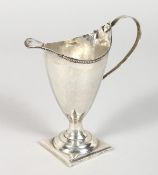 A GEORGE III HELMET SHAPED CREAM JUG. London 1784. Maker: John Lamb.