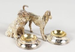 A GOOD PAIR OF SILVER PLATE DOG SALTS.
