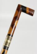 A VICTORIAN MULTI-COLOURED WOOD SWORD STICK. Stamped S. TOLEN FROM T. BROOKSBANK. 27ins long.
