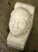 A RECONSTITUTED STONE CORBEL OF A MANS HEAD. 19ins high x 8ins wide x 14ins deep.