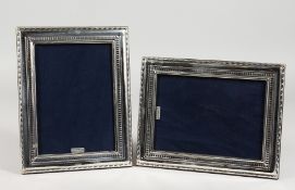 A PAIR OF MODERN SILVER PHOTOGRAPH FRAMES. 8.75ins x 7ins.