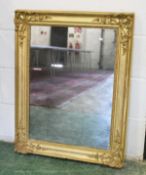 A 19TH CENTURY FRENCH GILT FRAMED MIRROR, with decorative moulded corners and original glass. 2ft